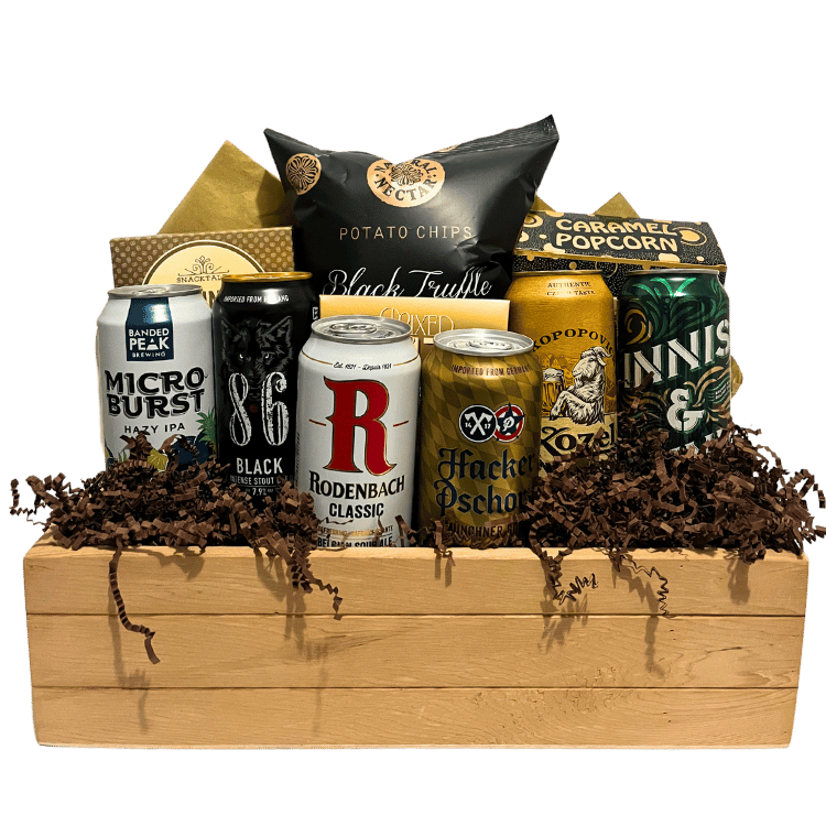 Unwrapped gift basket displayed in a wooden crate, featuring a selection of premium tall beers and savoury snacks.